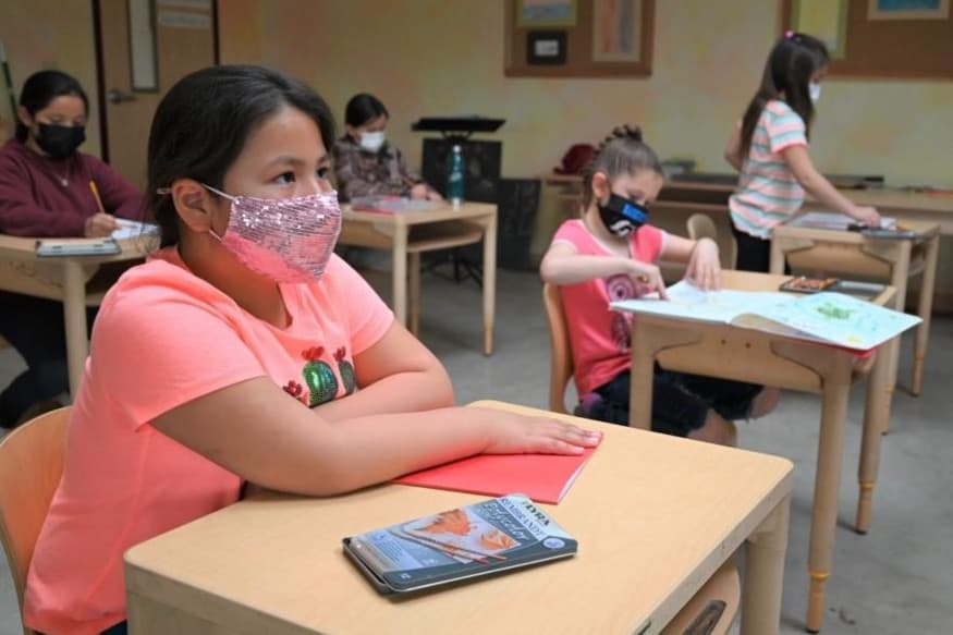 Student with mask at desk